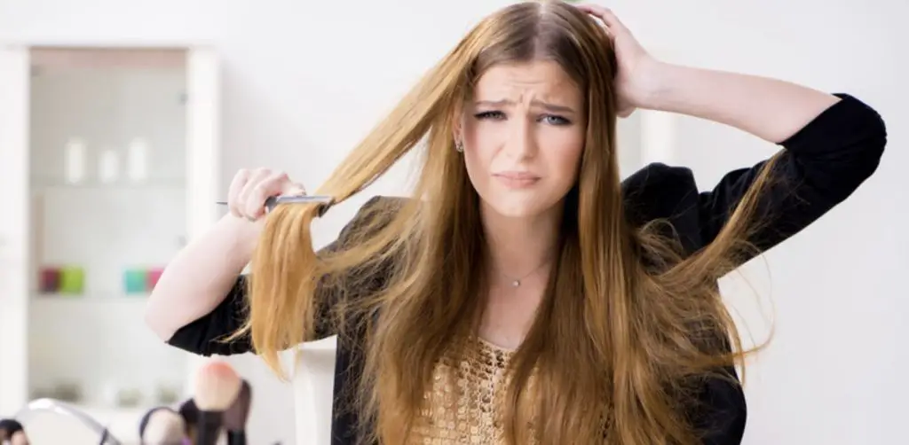 Woman with long hair thinking how to prevent it